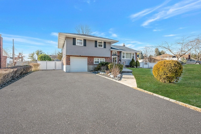 split level home featuring a garage and a front lawn