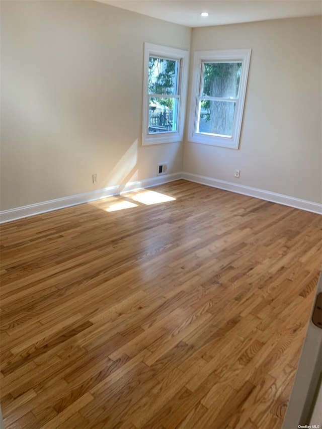 unfurnished room with light hardwood / wood-style flooring