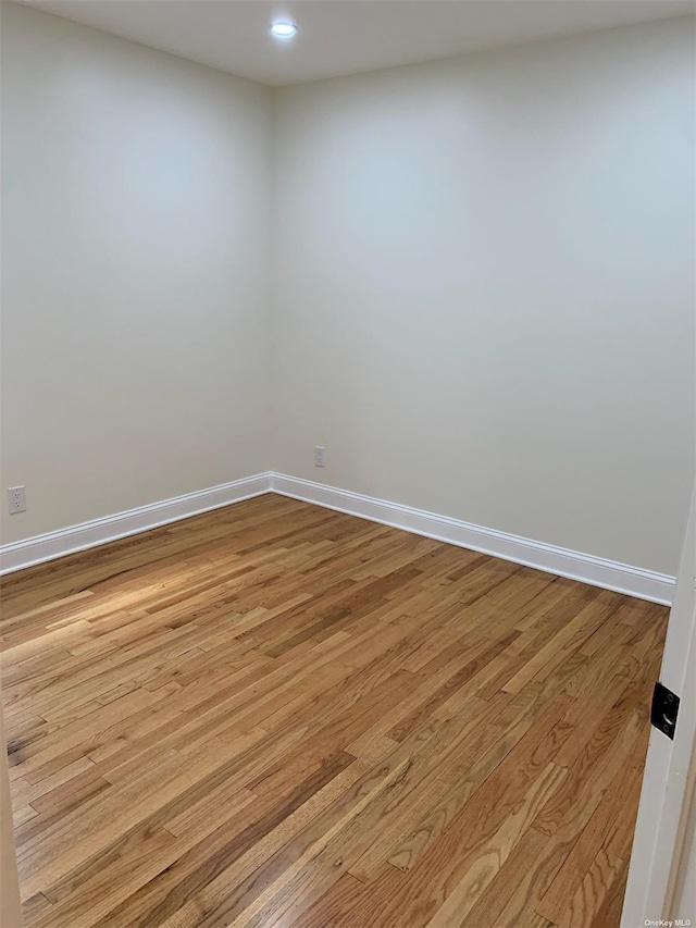 empty room with light hardwood / wood-style flooring