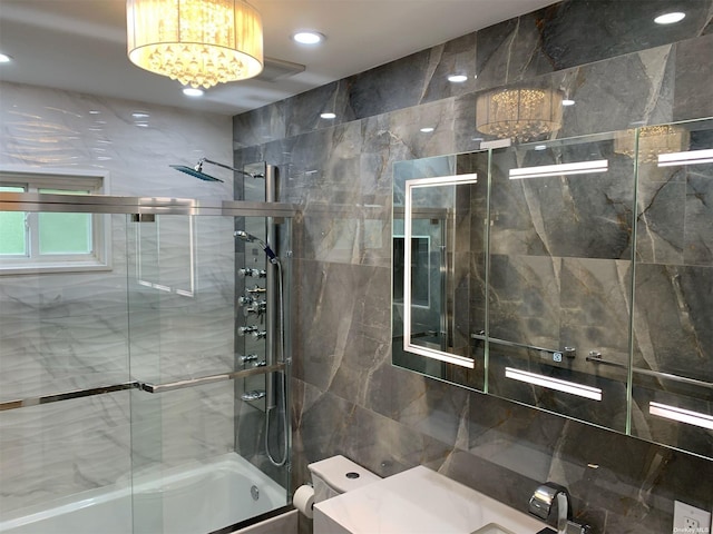 bathroom with enclosed tub / shower combo, a chandelier, and toilet