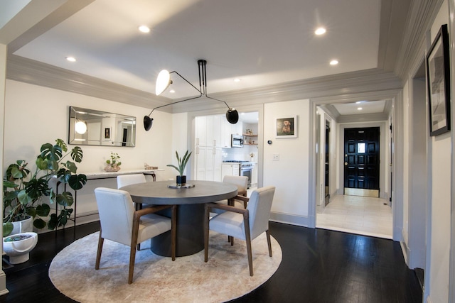 dining area with crown molding and light hardwood / wood-style flooring