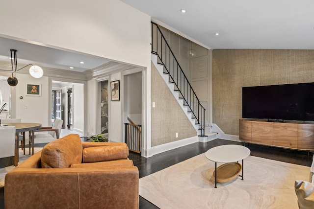 living room featuring dark wood-type flooring and crown molding