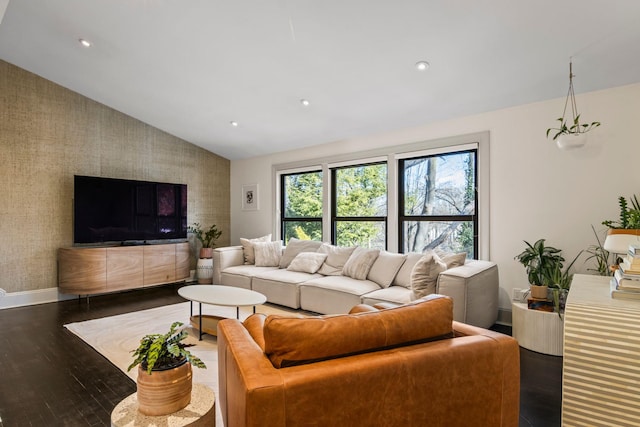 living room featuring dark hardwood / wood-style flooring and vaulted ceiling