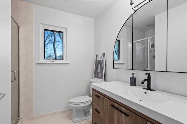 bathroom with a shower with door, vanity, tile patterned flooring, and toilet