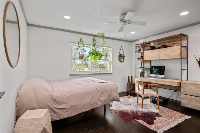 bedroom featuring ceiling fan, ornamental molding, and dark hardwood / wood-style floors