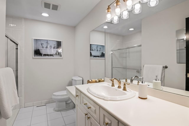 bathroom featuring tile patterned flooring, vanity, and toilet