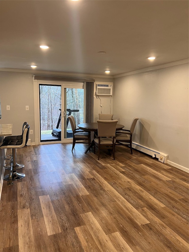 dining space with a wall mounted air conditioner, dark wood-type flooring, and ornamental molding