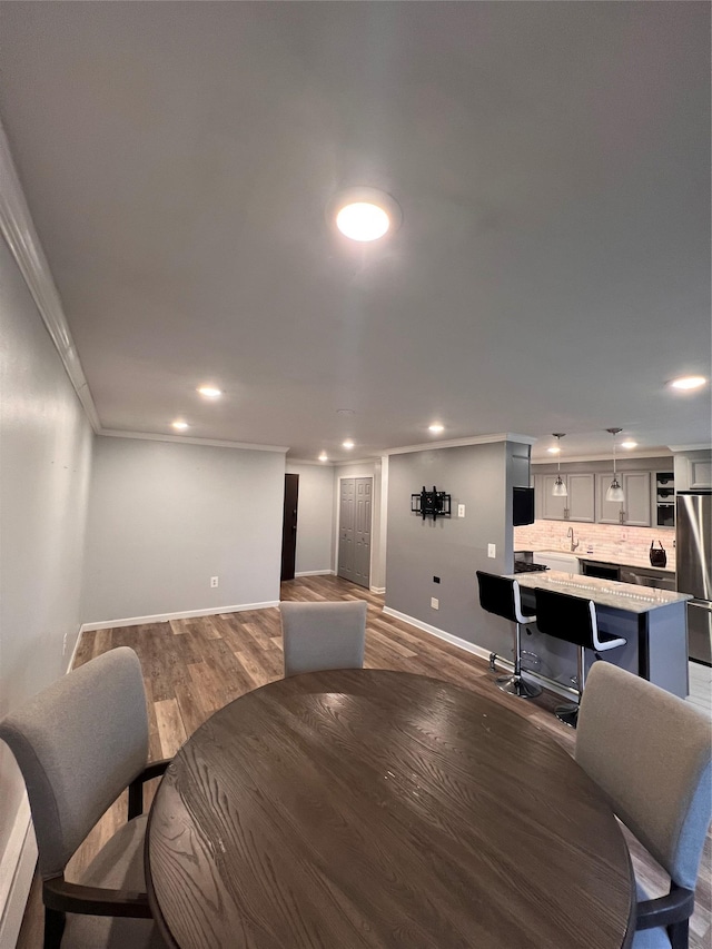 dining room featuring ornamental molding and dark hardwood / wood-style floors