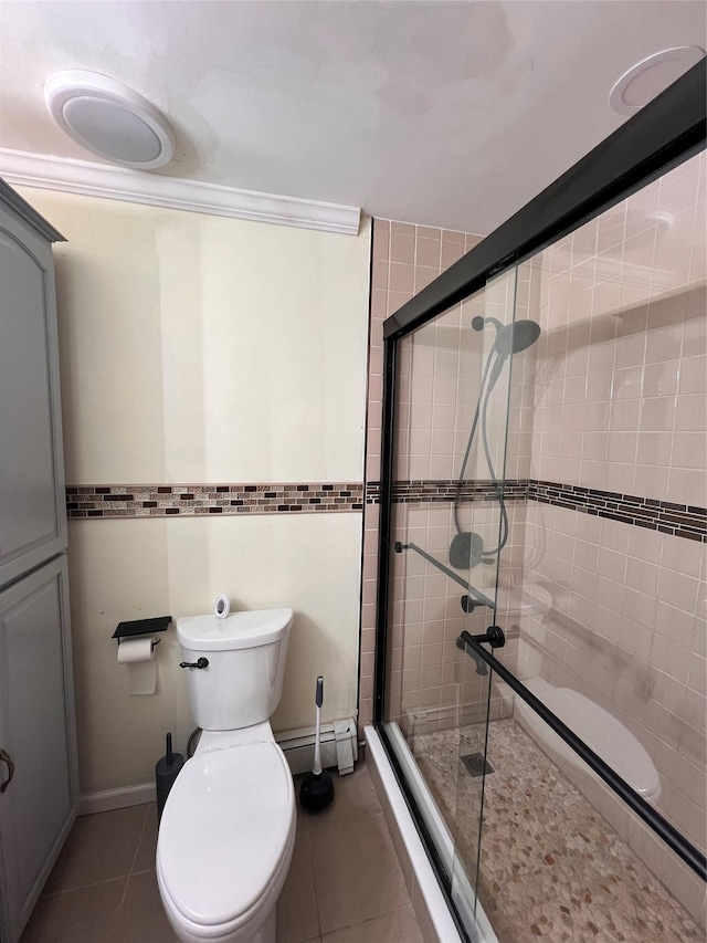 bathroom with tile patterned flooring, a shower with shower door, a baseboard radiator, and toilet