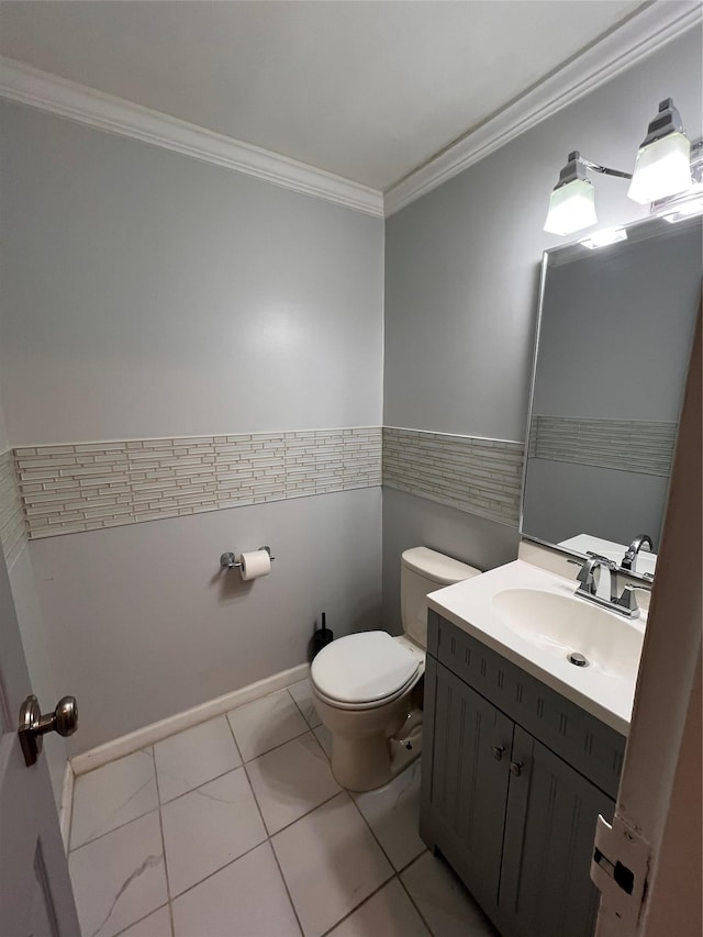 bathroom featuring tile patterned floors, ornamental molding, toilet, and vanity