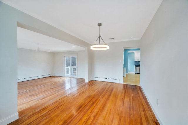 unfurnished room featuring a baseboard heating unit, visible vents, baseboards, light wood-style floors, and baseboard heating