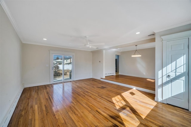 empty room featuring baseboards, light wood finished floors, and baseboard heating