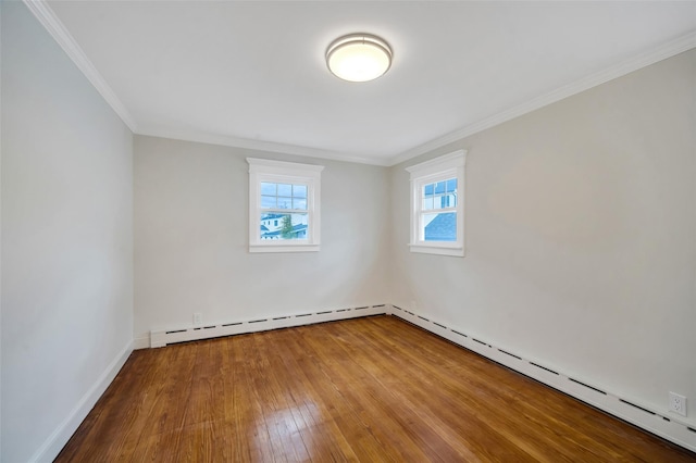 unfurnished room with a baseboard heating unit, ornamental molding, hardwood / wood-style flooring, and baseboards