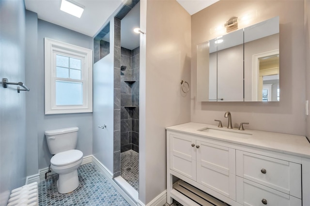 full bathroom featuring radiator heating unit, toilet, vanity, tiled shower, and baseboards