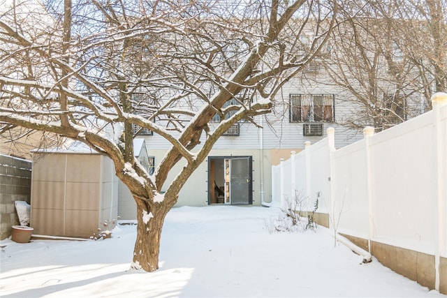 view of snow covered back of property