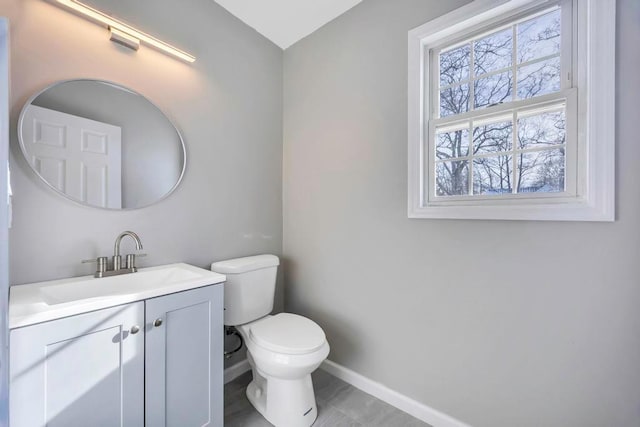 bathroom with vanity, tile patterned floors, and toilet