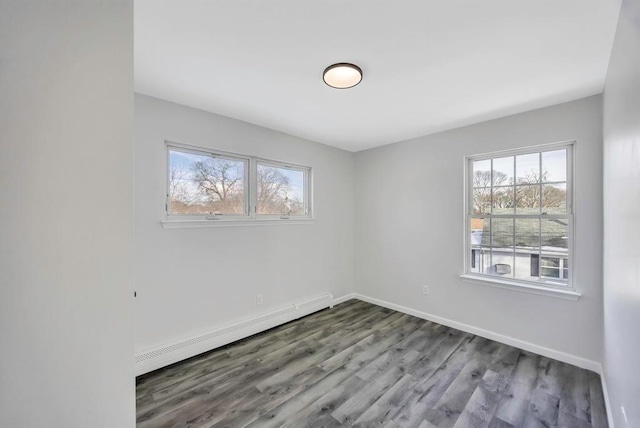 spare room featuring hardwood / wood-style flooring and a baseboard radiator