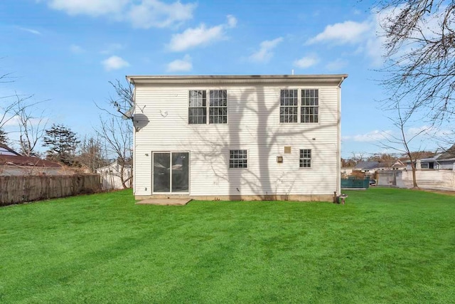 rear view of house featuring a yard