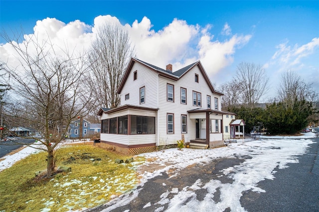 view of front of property featuring a sunroom