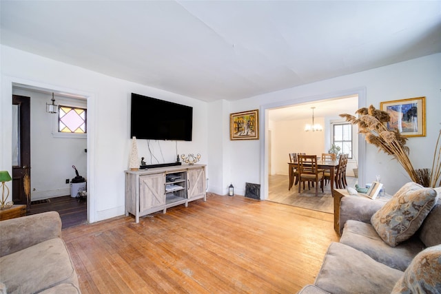 living room featuring wood-type flooring and a chandelier