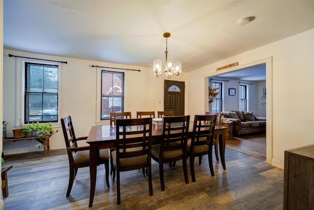 dining room featuring an inviting chandelier and dark hardwood / wood-style floors