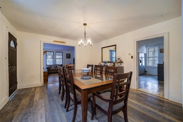 dining room with an inviting chandelier and dark hardwood / wood-style floors