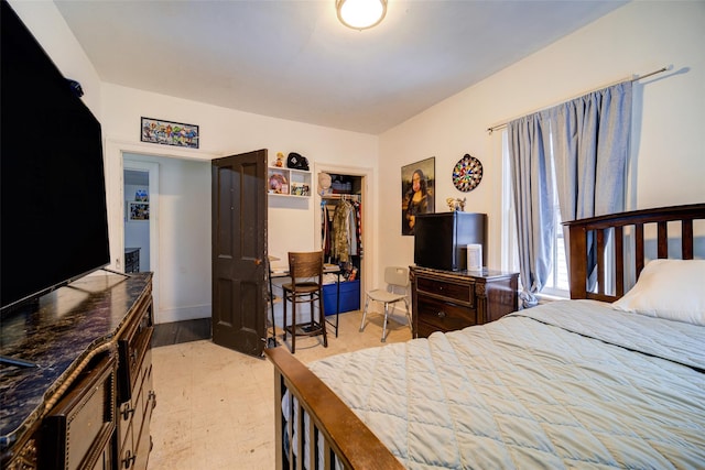 bedroom with a walk in closet and a closet