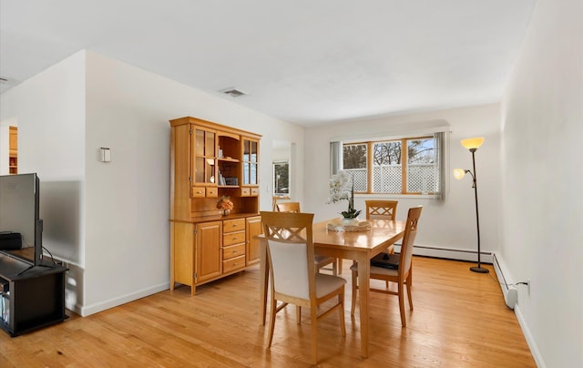 dining space with light hardwood / wood-style flooring