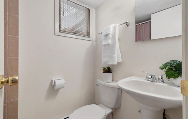 bathroom featuring toilet and sink