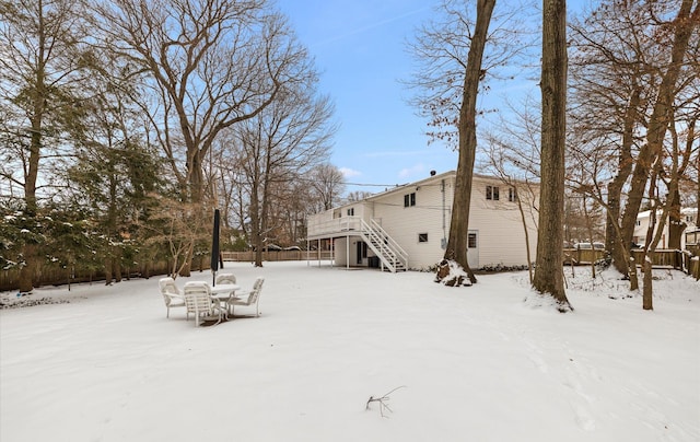 snowy yard with a deck