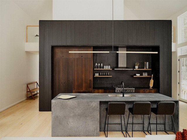 bar featuring sink and light hardwood / wood-style flooring