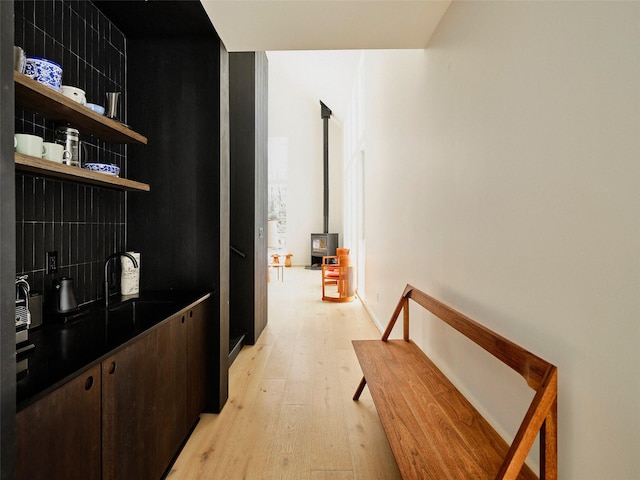 hallway with sink and light wood-type flooring