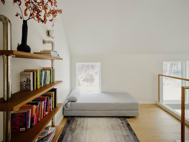 bedroom with lofted ceiling and light hardwood / wood-style flooring