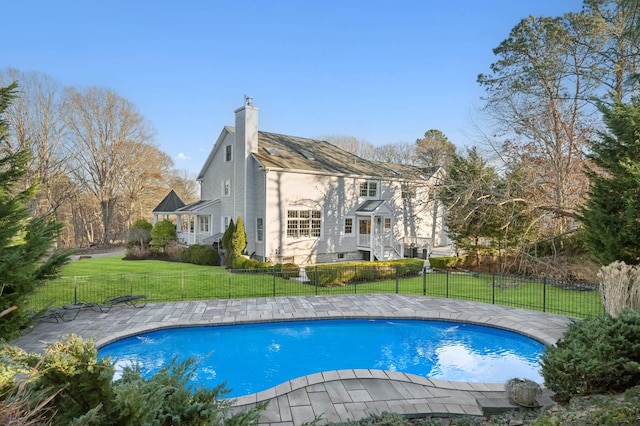 view of pool featuring a yard