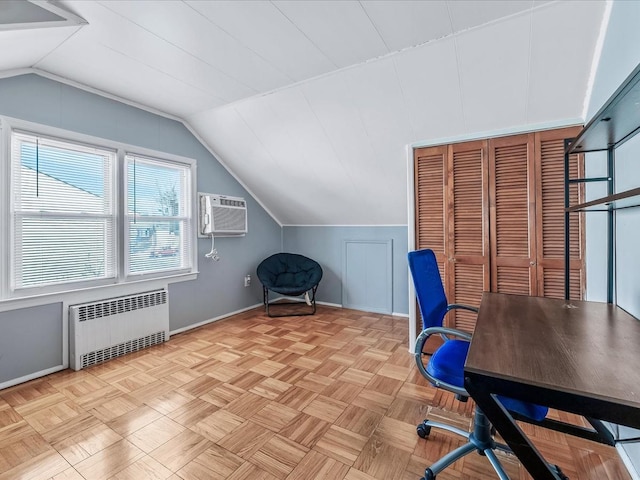 unfurnished office with light parquet floors, radiator heating unit, a wall mounted AC, and vaulted ceiling