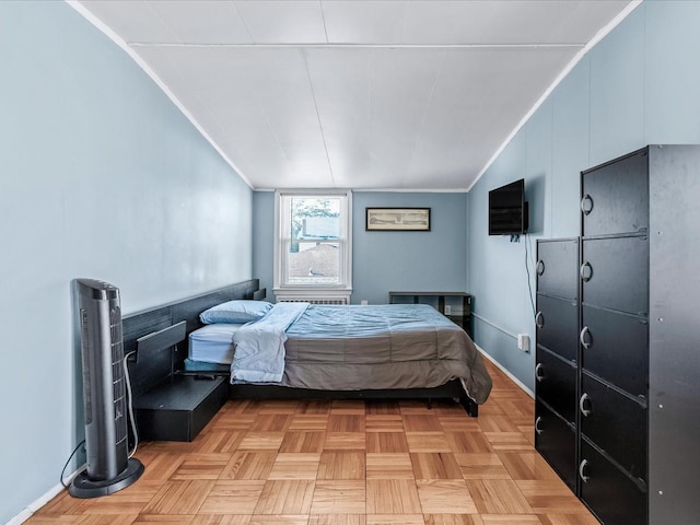 bedroom with light parquet floors and ornamental molding