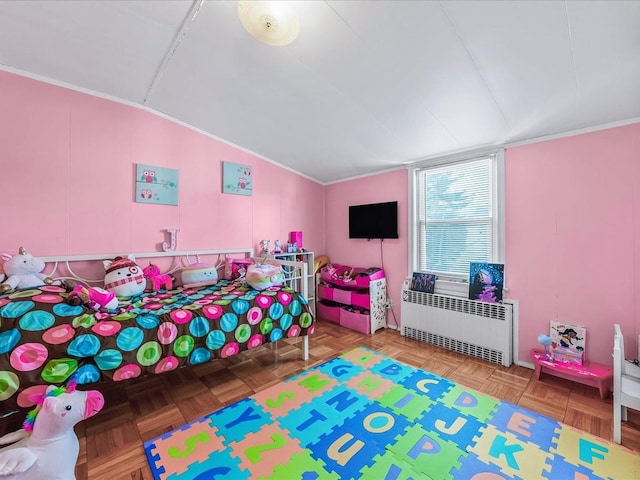 bedroom with parquet floors, radiator, and vaulted ceiling