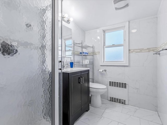 bathroom featuring toilet, an enclosed shower, tile walls, vanity, and radiator