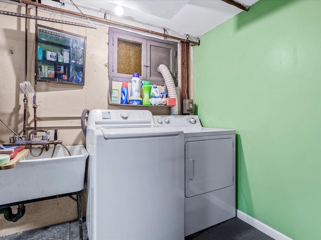 clothes washing area featuring washer and dryer and sink