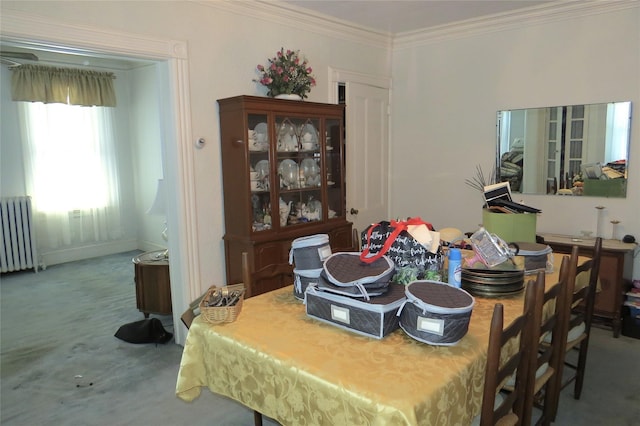 carpeted dining area featuring ornamental molding and radiator