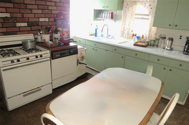 kitchen featuring sink, white appliances, brick wall, and green cabinets