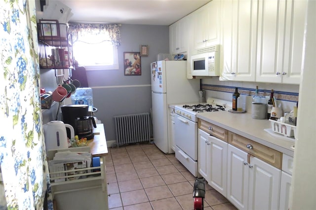 kitchen with white cabinetry, radiator heating unit, white appliances, and light tile patterned floors