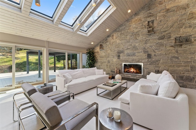 interior space with a fireplace, lofted ceiling with skylight, and wooden ceiling