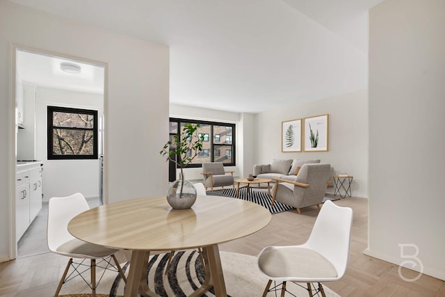 dining area featuring light parquet floors