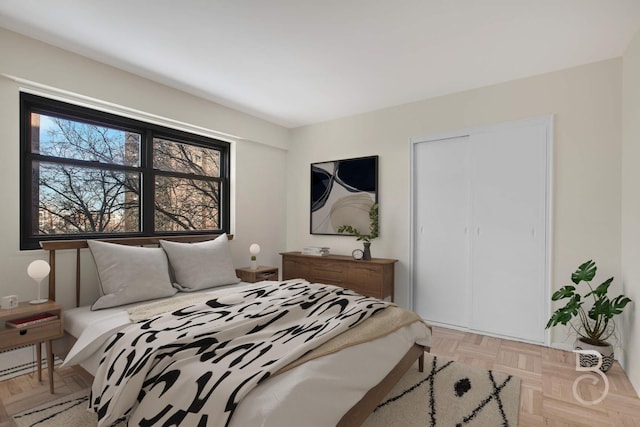 bedroom with light parquet flooring