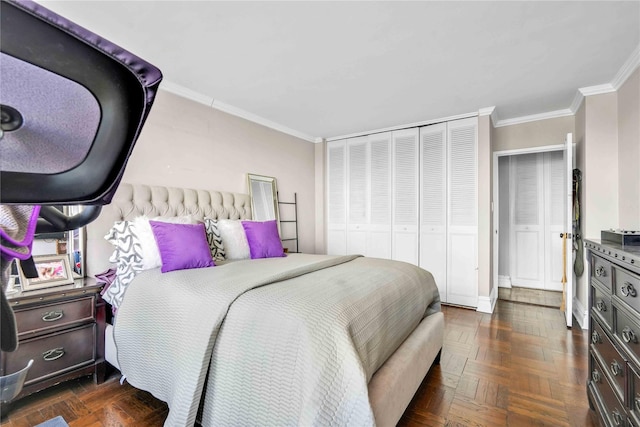 bedroom with a closet, ornamental molding, and dark parquet flooring