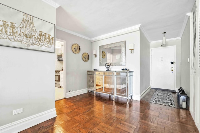 foyer with ornamental molding and parquet flooring