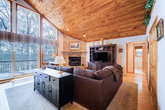 161 Barker Rd, Glen Spey, NY 12737 - living area with high vaulted ceiling, wood ceiling, a stone fireplace, and light wood-style flooring