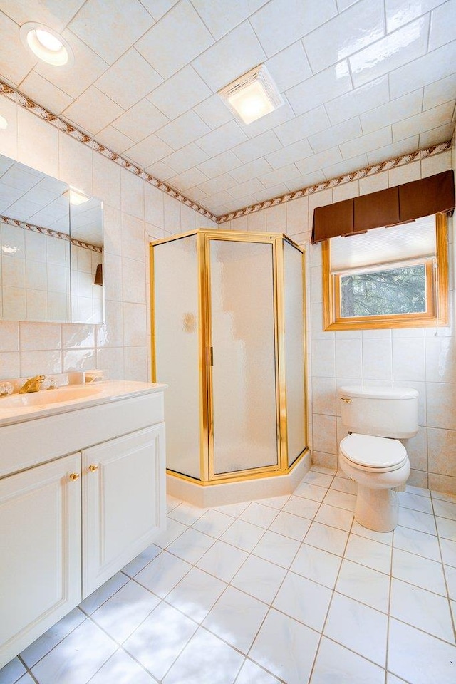 161 Barker Rd, Glen Spey, NY 12737 - full bathroom with tile walls, a stall shower, vanity, toilet, and tile patterned floors