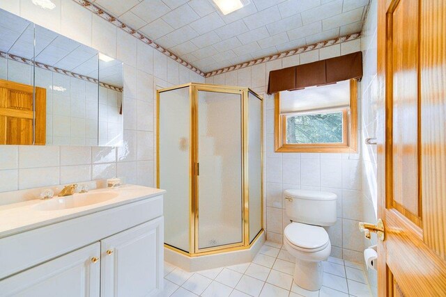161 Barker Rd, Glen Spey, NY 12737 - bathroom featuring tile walls, a stall shower, tile patterned flooring, toilet, and vanity